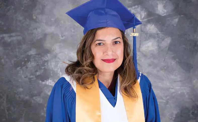 Simarjit smiles in her grad gown. She is proud to have completed another level of education at Stenberg College.
