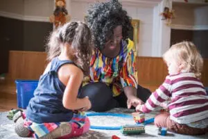 Early Childhood Educator working with children. Learn how to perform well at an Education Job Interview. 