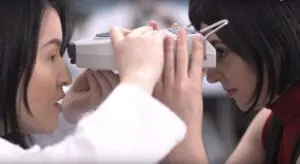 Optician measuring the distance between pupils on a patient. The Pupilometer is the tool necessary for taking PD measurements.