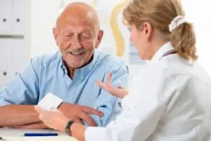 Health Care Assistant communicating with elderly person. Language skills are an important asset for a caregiver.